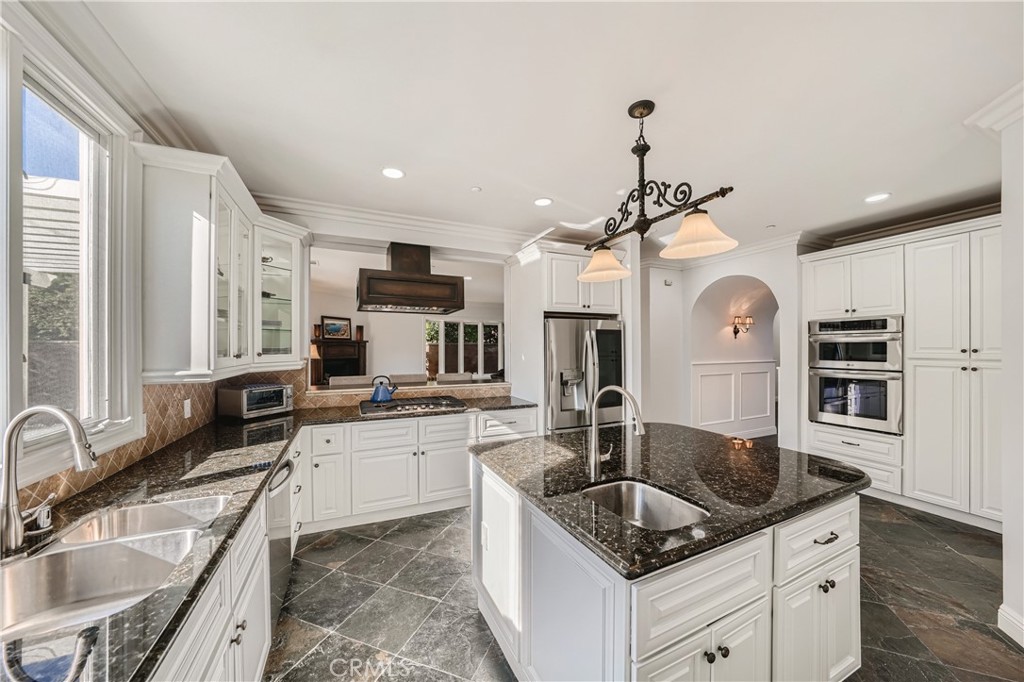 371 22nd Street Costa Mesa, CA 92627 - Photo 11 of 51 a kitchen with granite countertop a sink a counter top space appliances and cabinets
