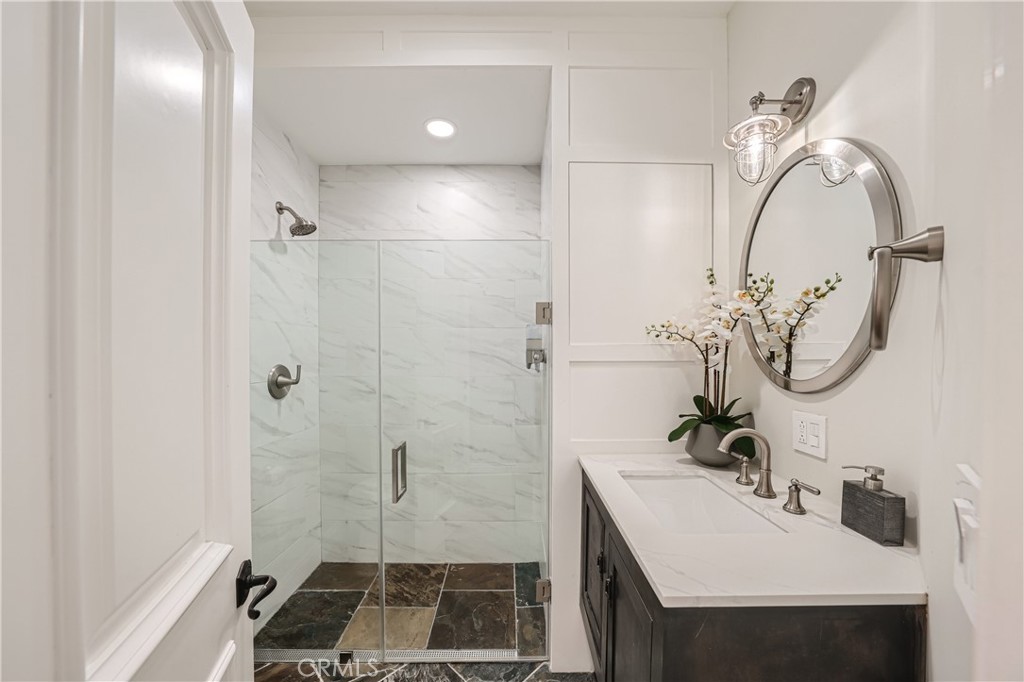 371 22nd Street Costa Mesa, CA 92627 - Photo 18 of 51 a bathroom with a sink and mirror