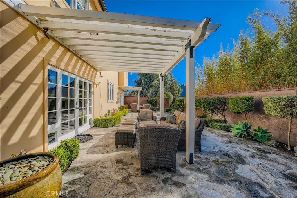371 22nd Street Costa Mesa, CA 92627 - Photo 25 of 51 a view of a patio with table and chairs potted plants and floor to ceiling window