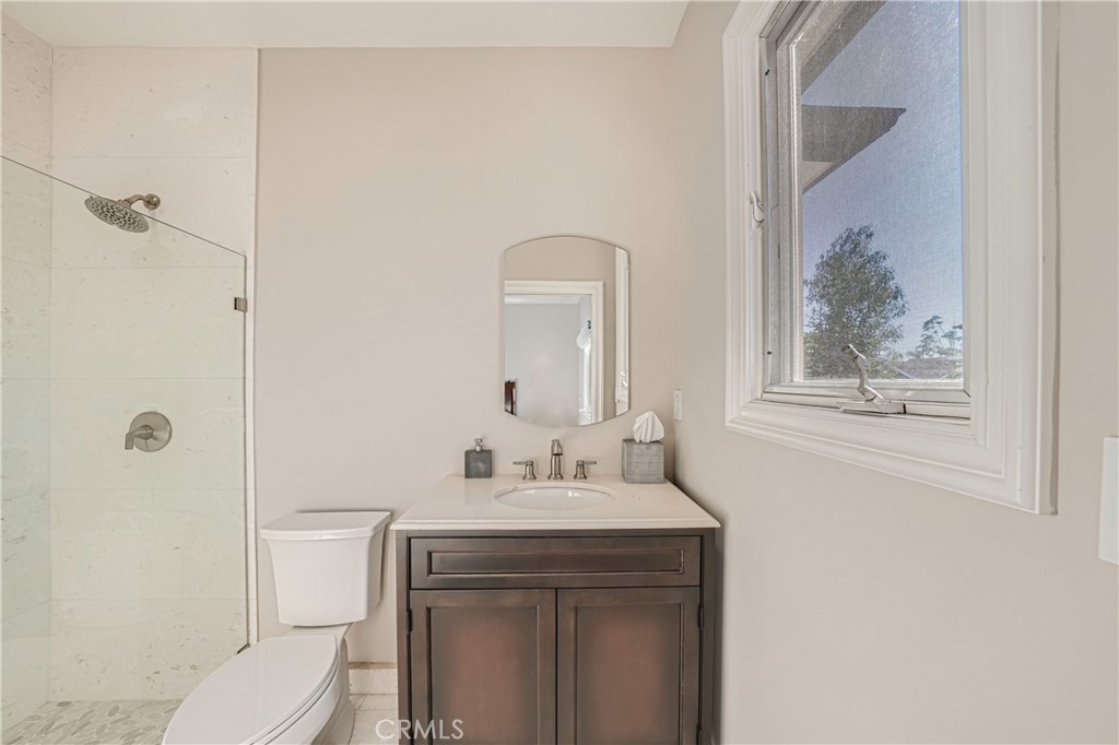 371 22nd Street Costa Mesa, CA 92627 - Photo 37 of 51 a bathroom with a toilet sink and mirror