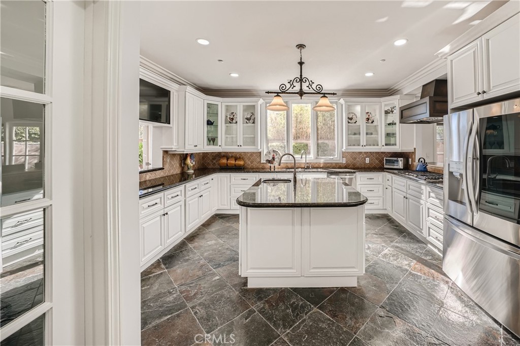 371 22nd Street Costa Mesa, CA 92627 - Photo 9 of 51 a kitchen with stainless steel appliances kitchen island granite countertop a sink and cabinets
