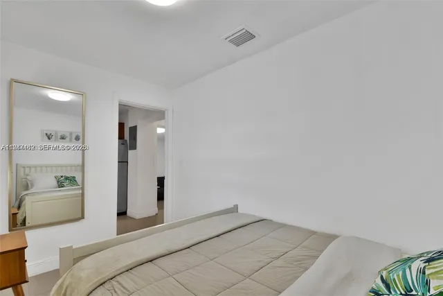 a bedroom with a bed and a couch