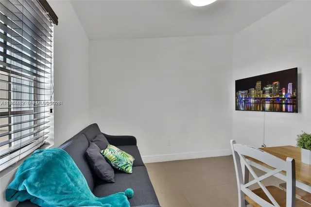 a living room with furniture and a lamp