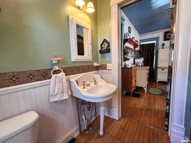 a bathroom with a sink a toilet and a mirror