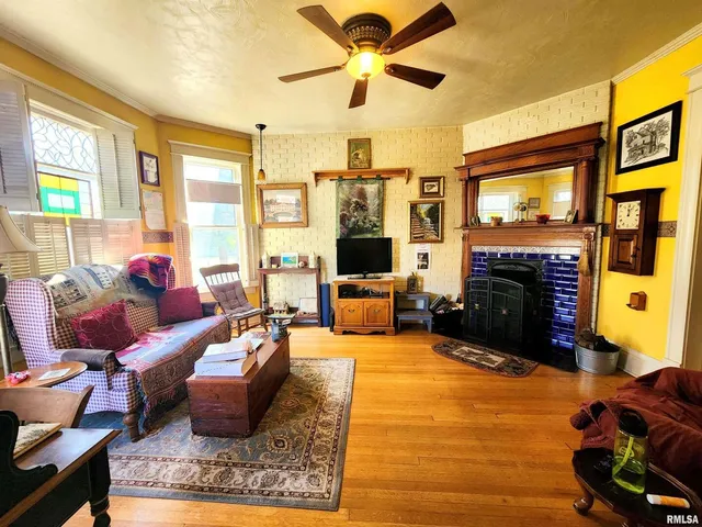 a living room with furniture fireplace and flat screen tv