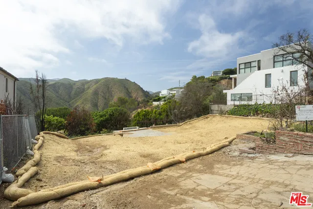 a view of a white house with a yard