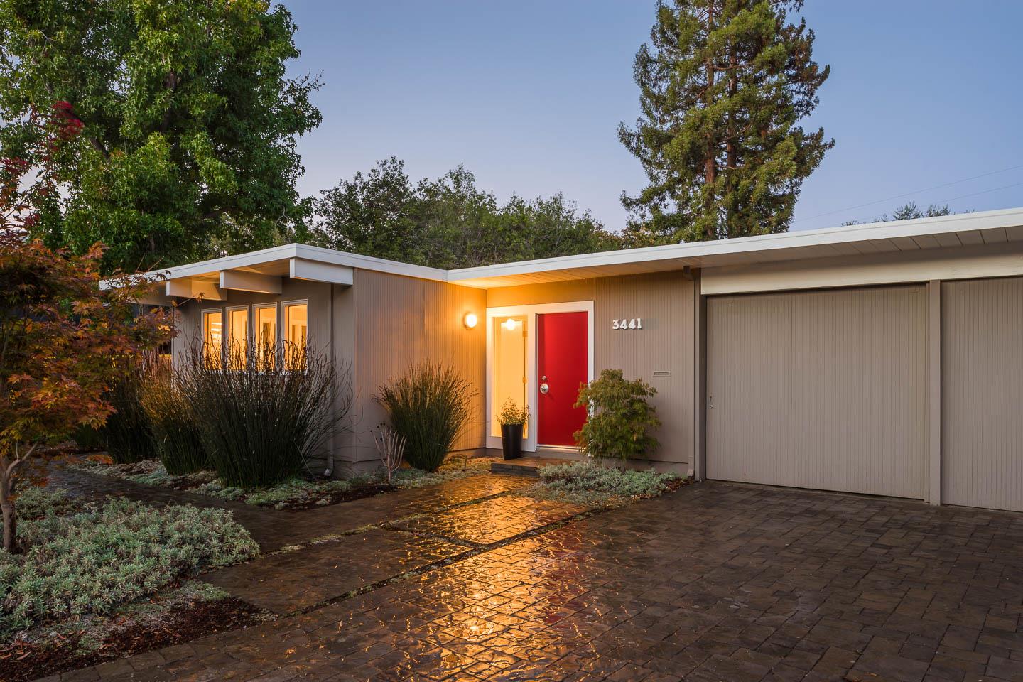 a backyard of a house with plants and trees