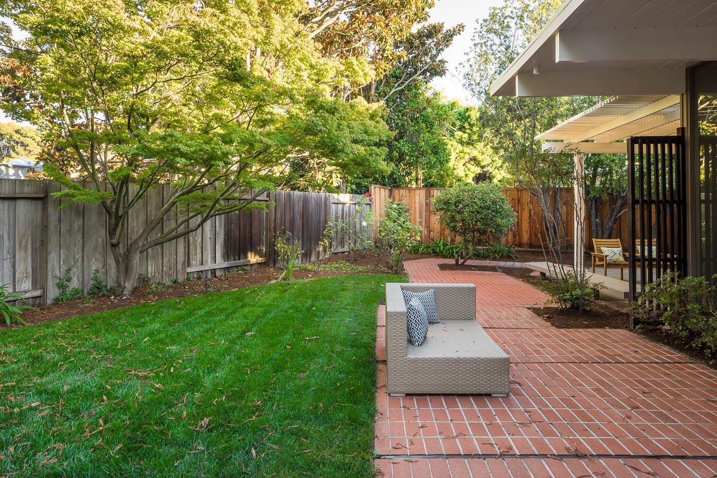 3441 Thomas Drive Palo Alto, CA 94303 - Photo 13 of 14 a view of a patio with table and chairs potted plants and wooden fence