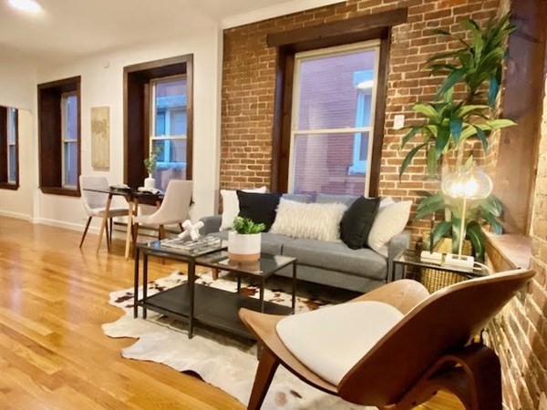 11 Unity Street, Unit 6 Boston, MA 02113 - Photo 3 of 12 a living room with furniture and wooden floor