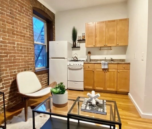 11 Unity Street, Unit 6 Boston, MA 02113 - Photo 5 of 12 a kitchen with a table and chairs in it