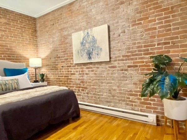 11 Unity Street, Unit 6 Boston, MA 02113 - Photo 6 of 12 a bedroom with a bed and a potted plant