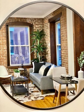 11 Unity Street, Unit 6 Boston, MA 02113 - Photo 7 of 12 a living room with a couch and a table