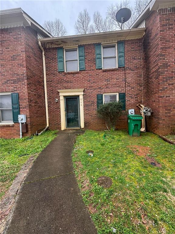 248 Walter Way Stone Mountain, GA 30083 - Photo 1 of 1 a view of a brick house with a yard and a large tree