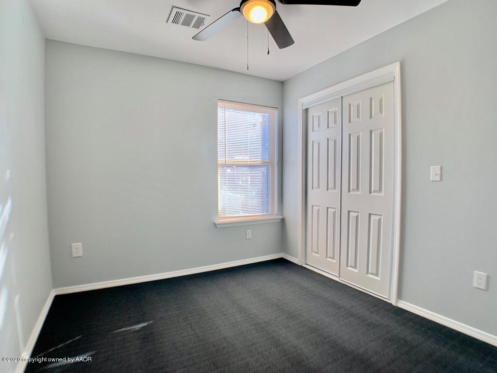 4213 South Harrison Street Amarillo, TX 79110 - Photo 11 of 14 an empty room with a ceiling fan and window