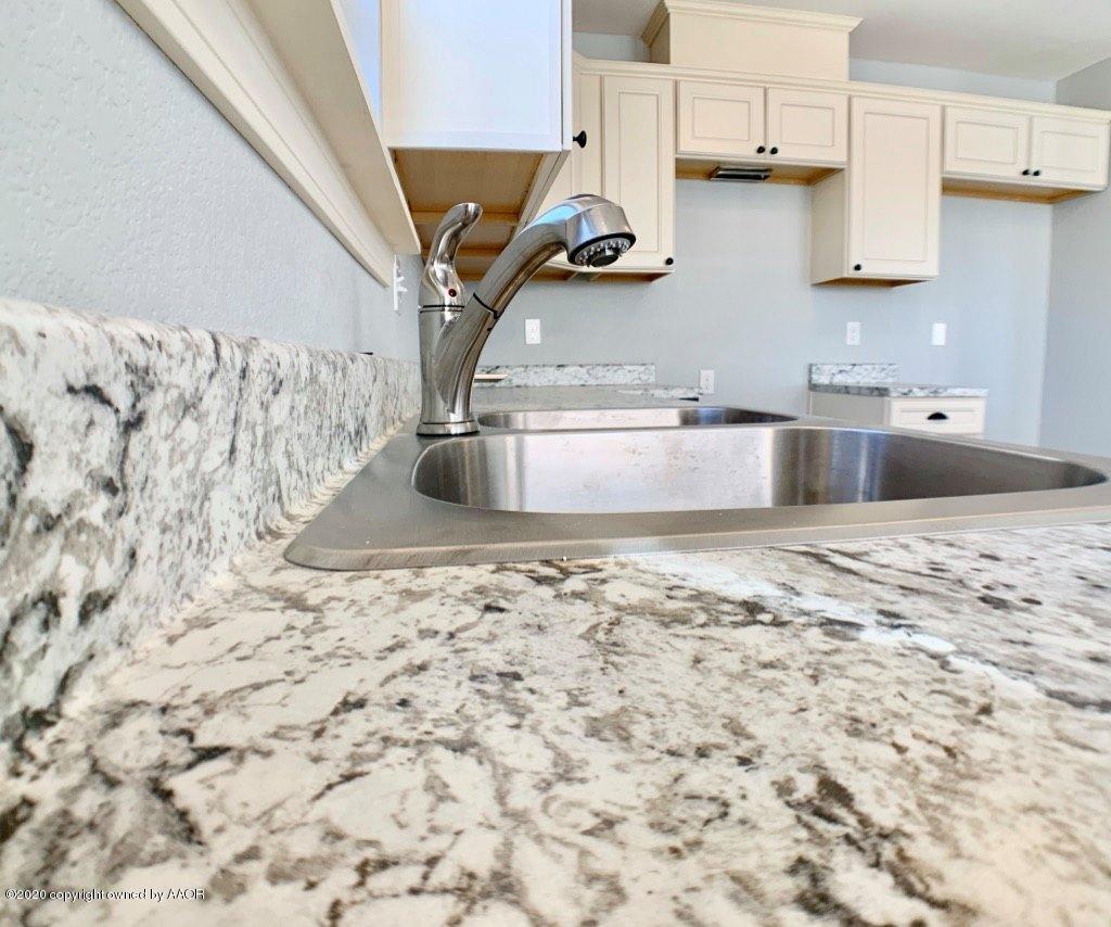 4213 South Harrison Street Amarillo, TX 79110 - Photo 5 of 14 a kitchen with a sink and a stove