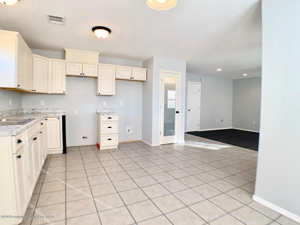 4213 South Harrison Street Amarillo, TX 79110 - Photo 6 of 14 a view of a kitchen with white cabinets
