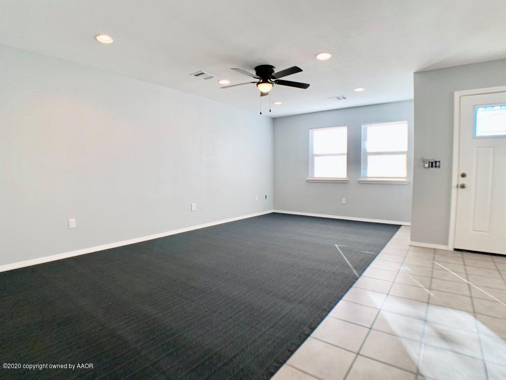 4213 South Harrison Street Amarillo, TX 79110 - Photo 8 of 14 an empty room with wooden floor and windows