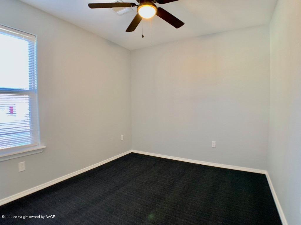4213 South Harrison Street Amarillo, TX 79110 - Photo 10 of 14 an empty room with a ceiling fan and wooden floor