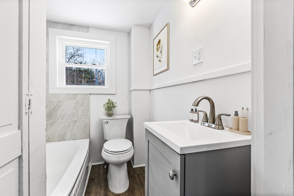597 Mendon Road Northbridge, MA 01534 - Photo 9 of 13 a bathroom with a toilet sink and mirror