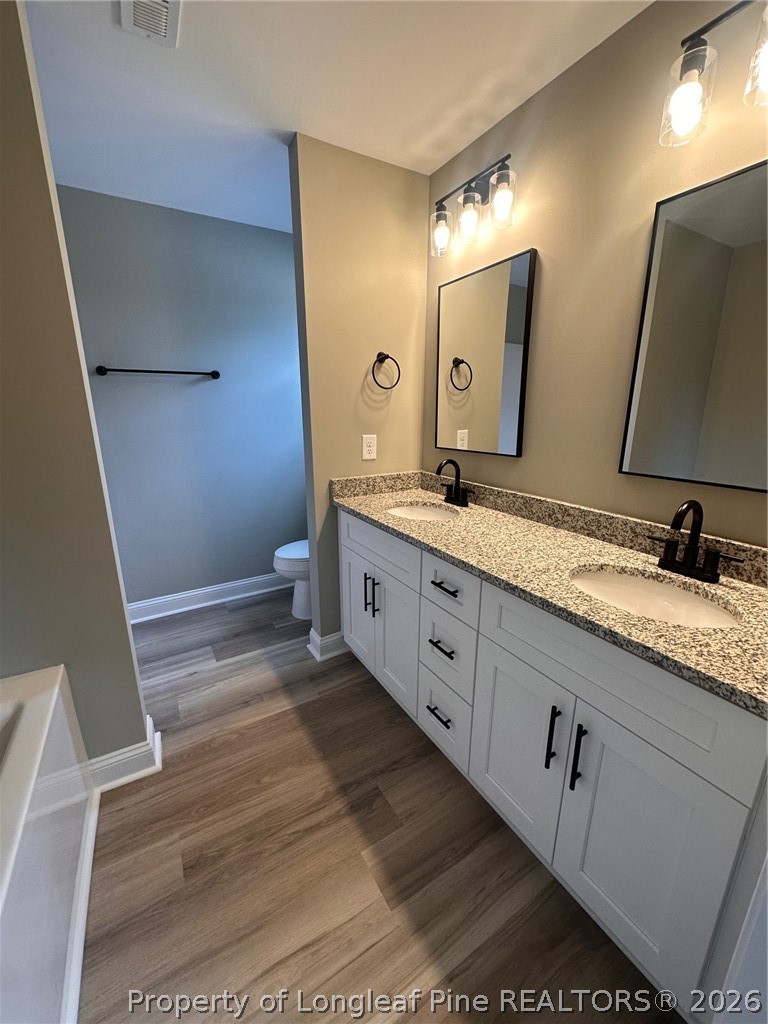 151 Merle Road Pinebluff, NC 28373 - Photo 8 of 12 a spacious bathroom with a granite countertop sink and a mirror