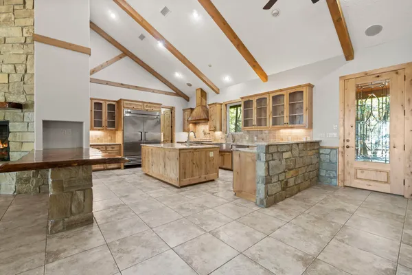 a kitchen with stainless steel appliances granite countertop a refrigerator and a sink