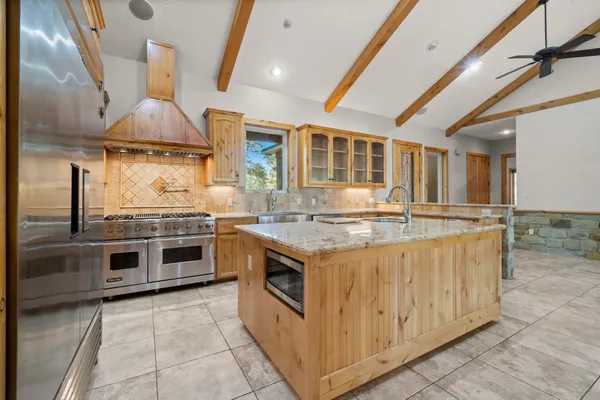 a kitchen with stainless steel appliances granite countertop a sink and a cabinets