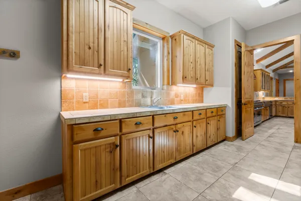 a spacious bedroom with a bed and wooden floor