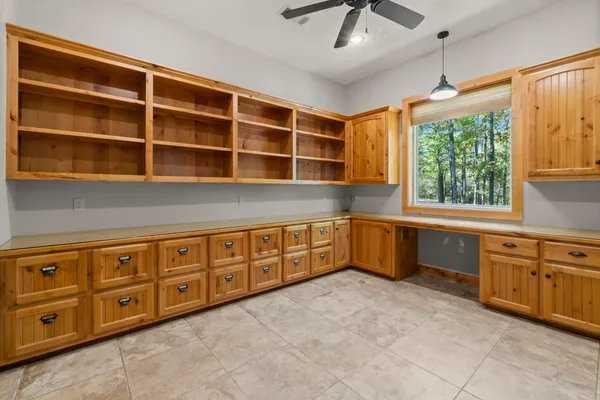 a view of a wooden bench next to a yard