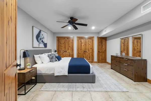 a view of yellow house with a big yard and large trees