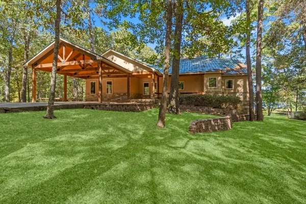a backyard of a house with table and chairs