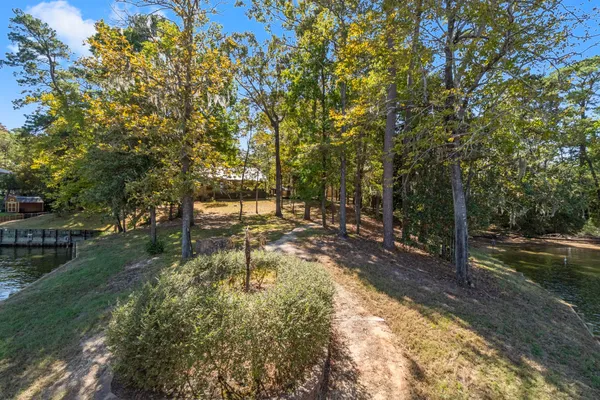 an aerial view of a house with a yard and lake view