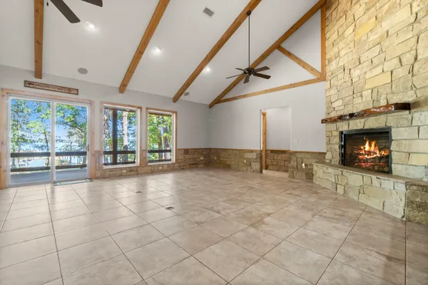 a view of empty room with wooden floor and fireplace