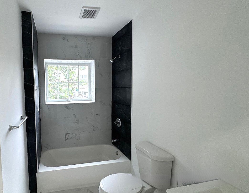 830 Hendrix Street Brooklyn, NY 11207 - Photo 11 of 25 a bathroom with a toilet and bathtub