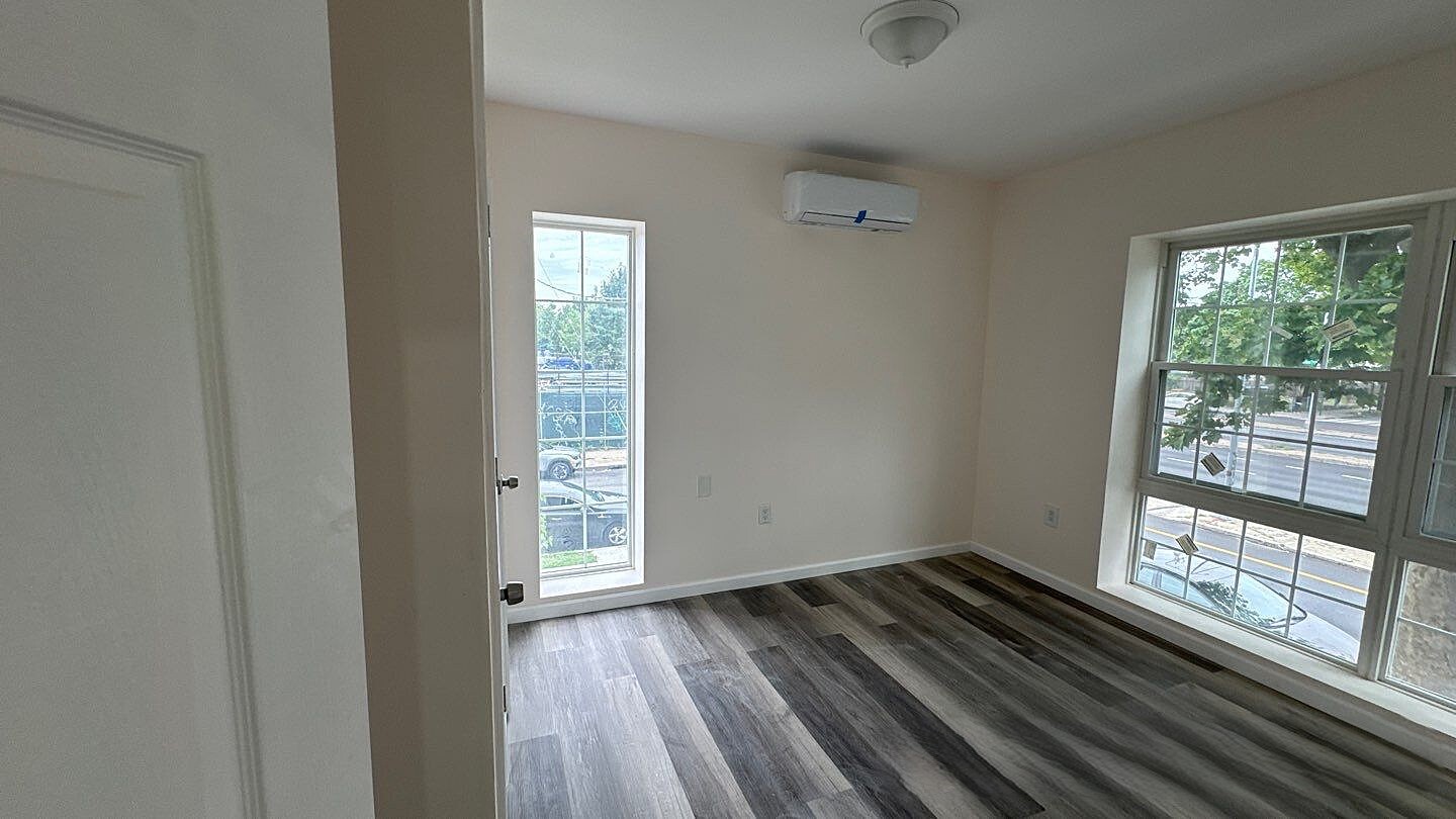 830 Hendrix Street Brooklyn, NY 11207 - Photo 13 of 25 a view of empty room with wooden floor and fan