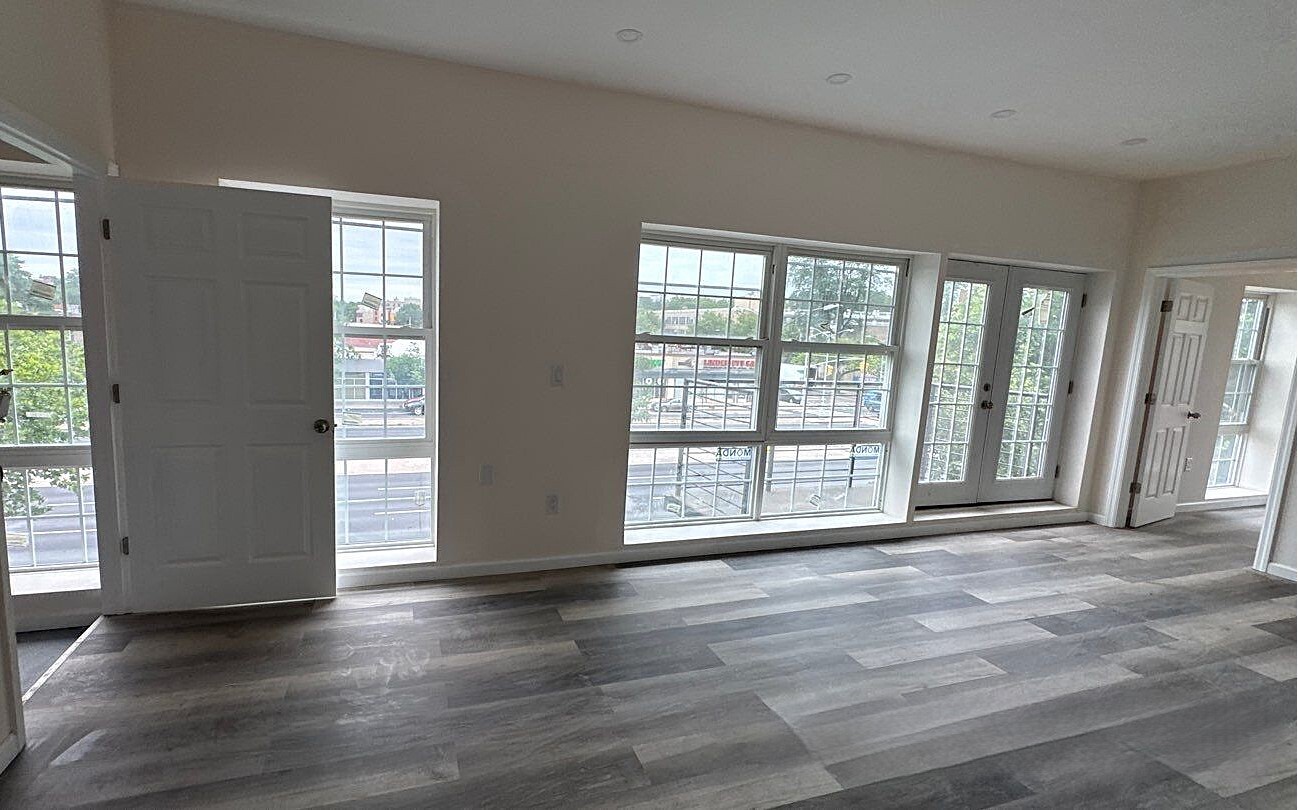 830 Hendrix Street Brooklyn, NY 11207 - Photo 18 of 25 a view of an empty room with wooden floor and a window