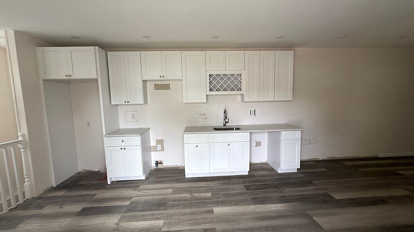 830 Hendrix Street Brooklyn, NY 11207 - Photo 19 of 25 a kitchen with stainless steel appliances white cabinets and a refrigerator
