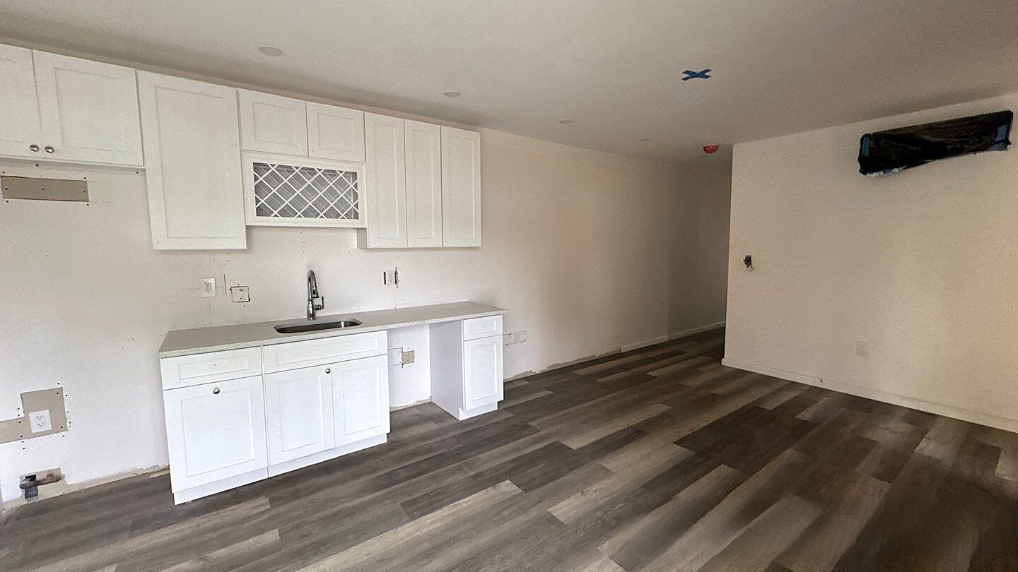 830 Hendrix Street Brooklyn, NY 11207 - Photo 20 of 25 a kitchen with granite countertop white cabinets and sink
