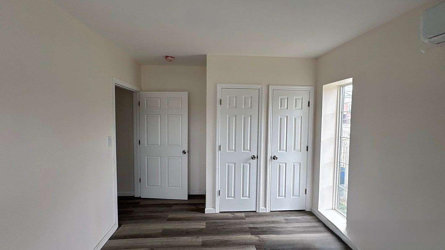 830 Hendrix Street Brooklyn, NY 11207 - Photo 24 of 25 a view of a livingroom with wooden floor and closet