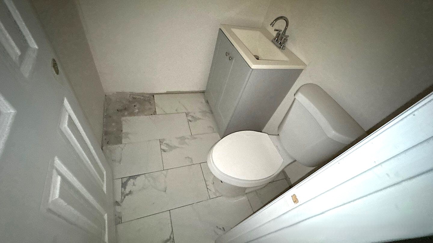 830 Hendrix Street Brooklyn, NY 11207 - Photo 25 of 25 a bathroom with a sink and toilet