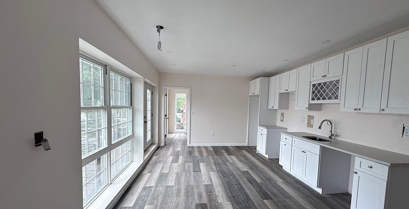 830 Hendrix Street Brooklyn, NY 11207 - Photo 4 of 25 a kitchen with cabinets a sink and wooden floor