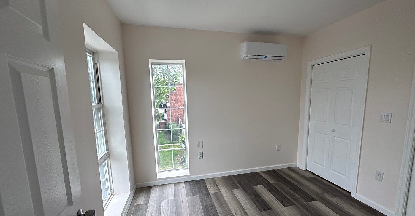 830 Hendrix Street Brooklyn, NY 11207 - Photo 6 of 25 a view of an empty room with wooden floor and a window