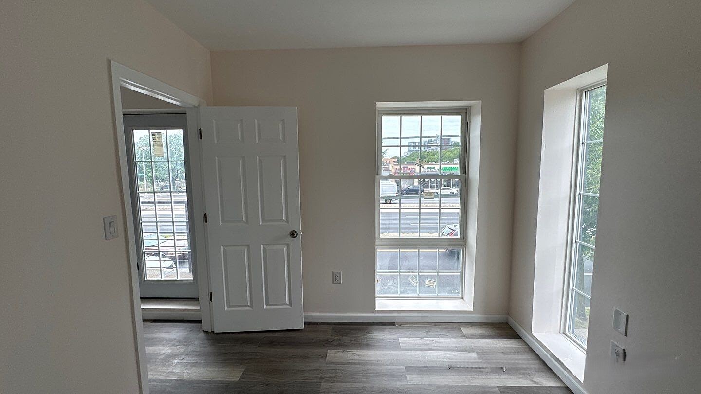 830 Hendrix Street Brooklyn, NY 11207 - Photo 8 of 25 a view of empty room with wooden floor and fan