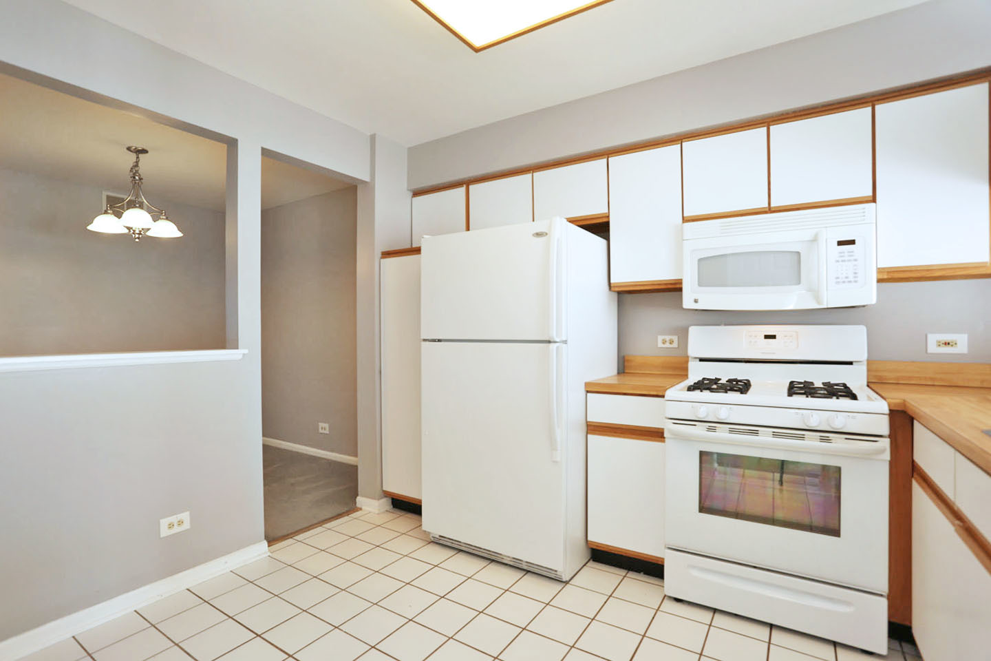 620 Cobblestone Court, Unit 620 Elgin, IL 60120 - Photo 7 of 25 a white refrigerator freezer and a stove sitting inside of a kitchen