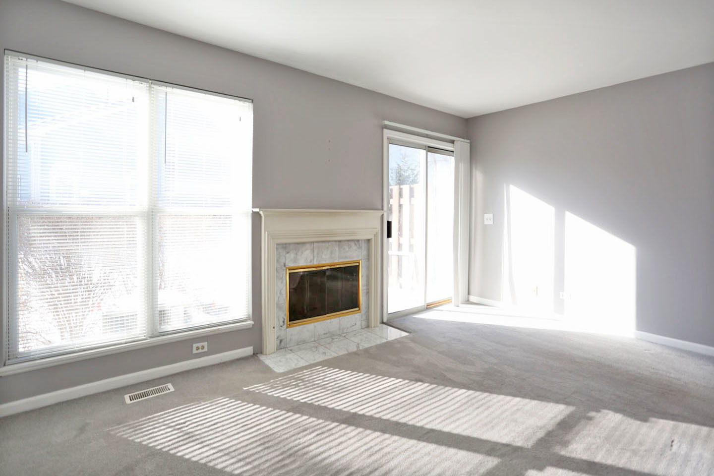 620 Cobblestone Court, Unit 620 Elgin, IL 60120 - Photo 10 of 25 a view of an empty room with a window and a fireplace