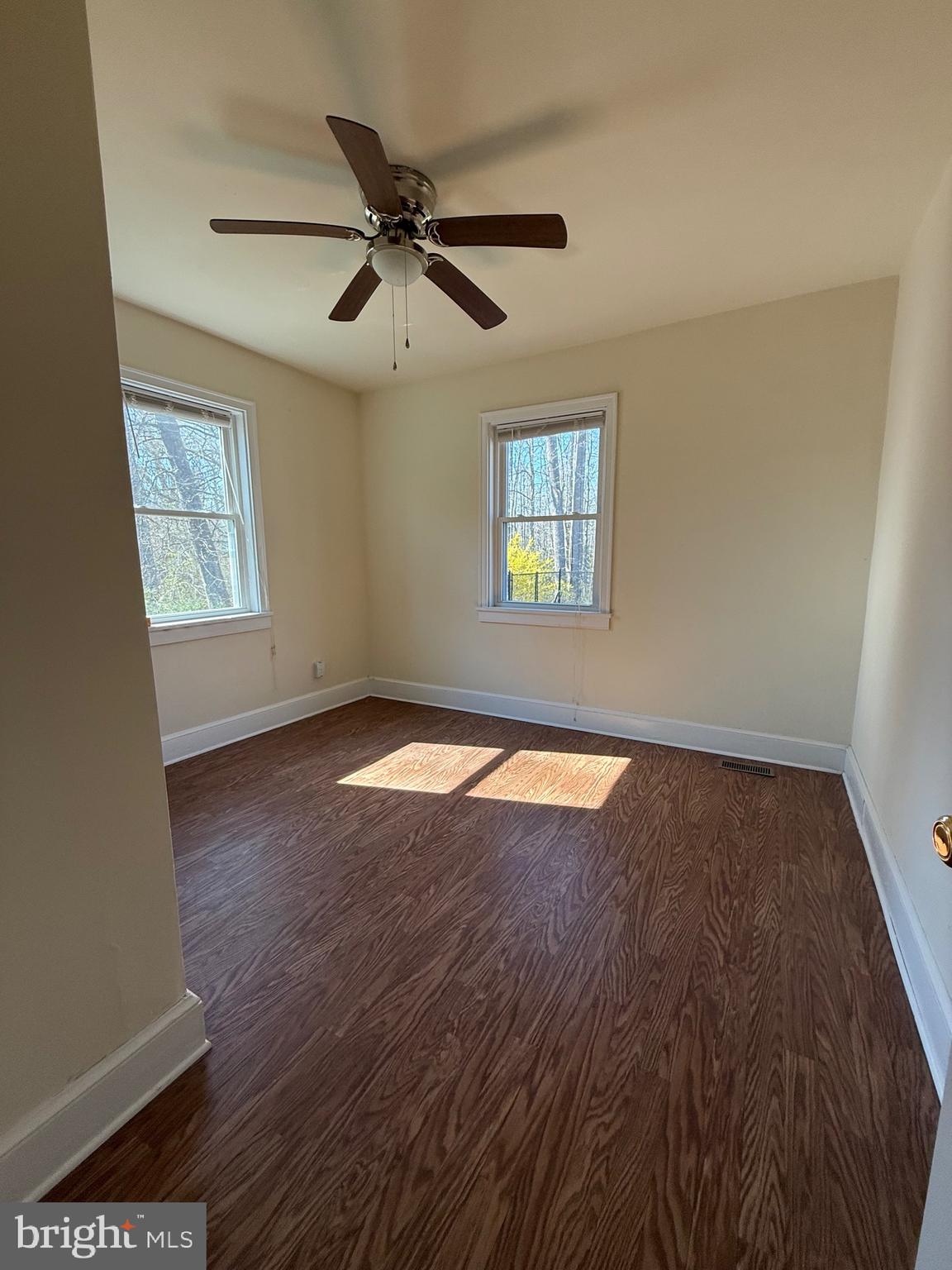 9253 Dahlgren Road King George, VA 22485 - Photo 19 of 23 a view of empty room with wooden floor and fan