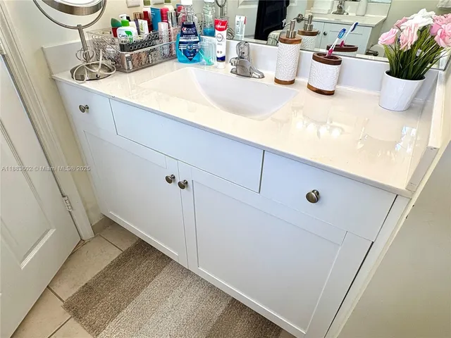a kitchen with a sink and potted plant