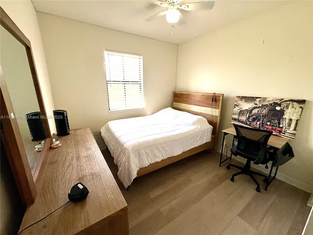 a bed sitting in a bedroom next to a window