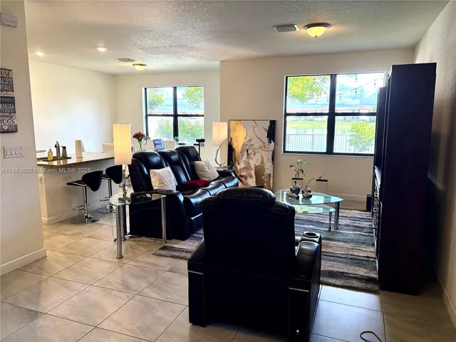 a dining room with furniture window and wooden floor