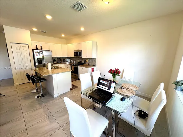 a work room with furniture a rug and white walls