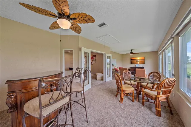 a view of a dining room with furniture and chandelier
